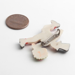 Art Deco celluloid pin brooch; running Top hat boy with flower bunch hand painted blue grey